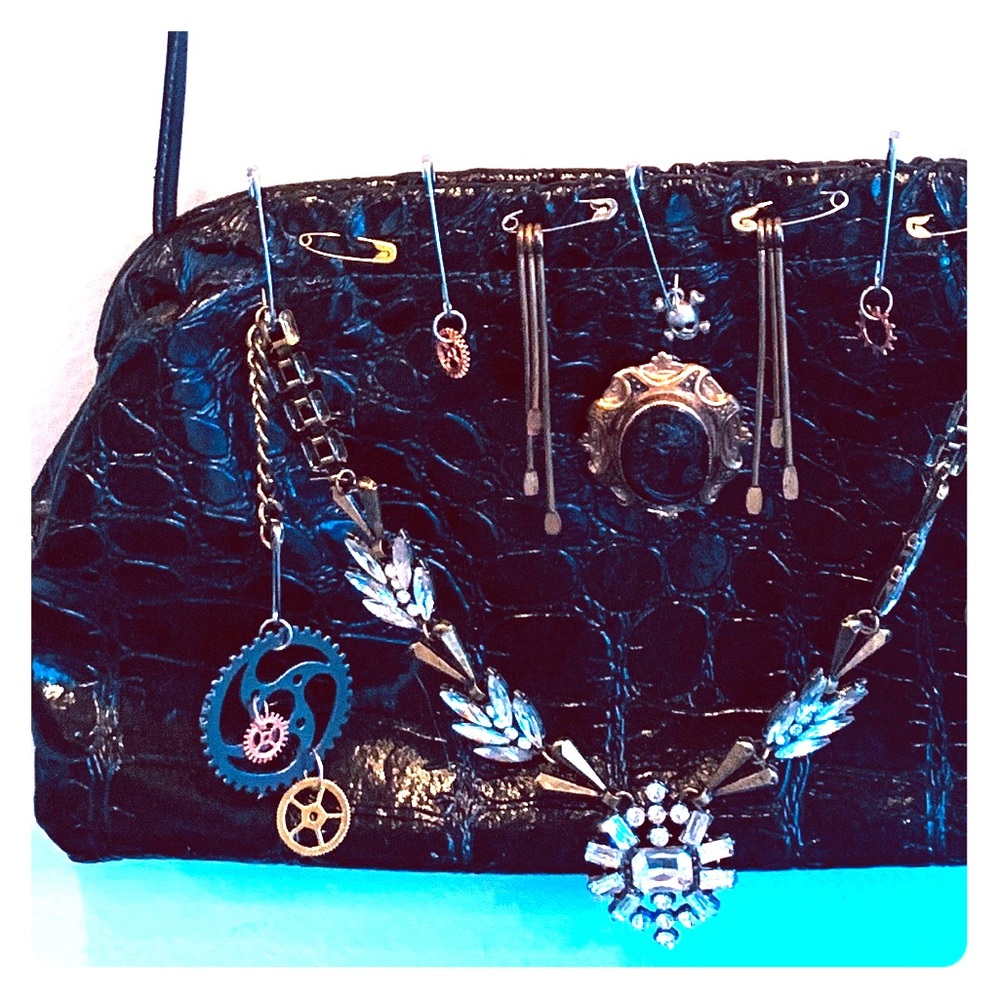 Steampunk purse with vintage pins and accessories